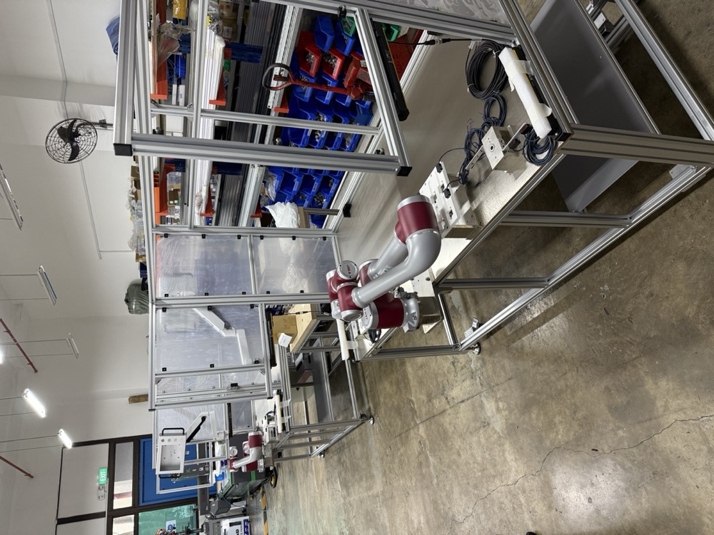Robot-integrated testing workstation with custom fixtures for consumer product quality verification and functional testing